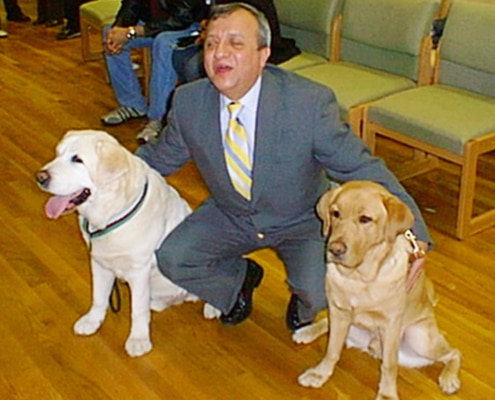 Omar Rivera with the two guide dogs, Salty and Montana